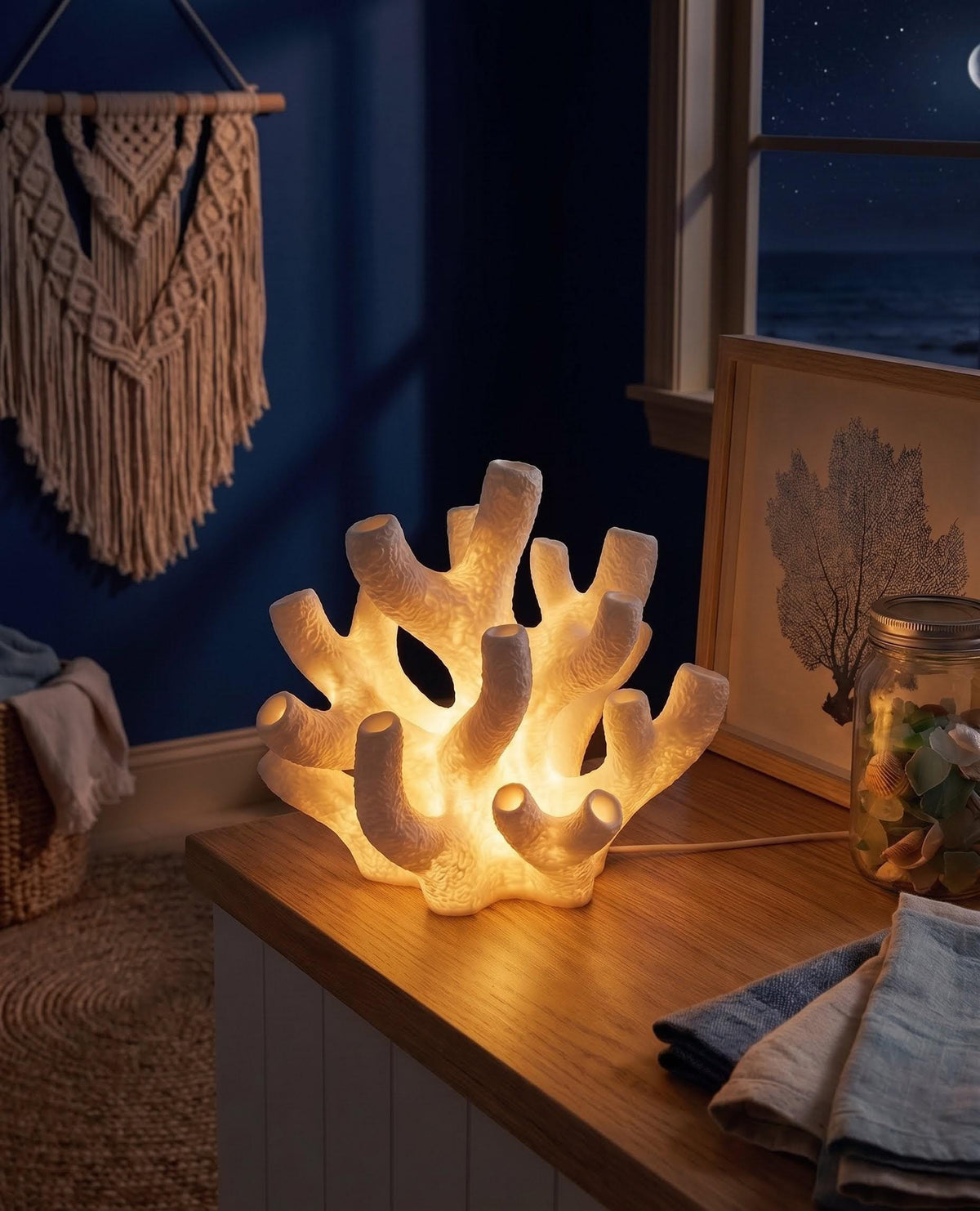 Coral Reef Lamp glowing on a coastal side table